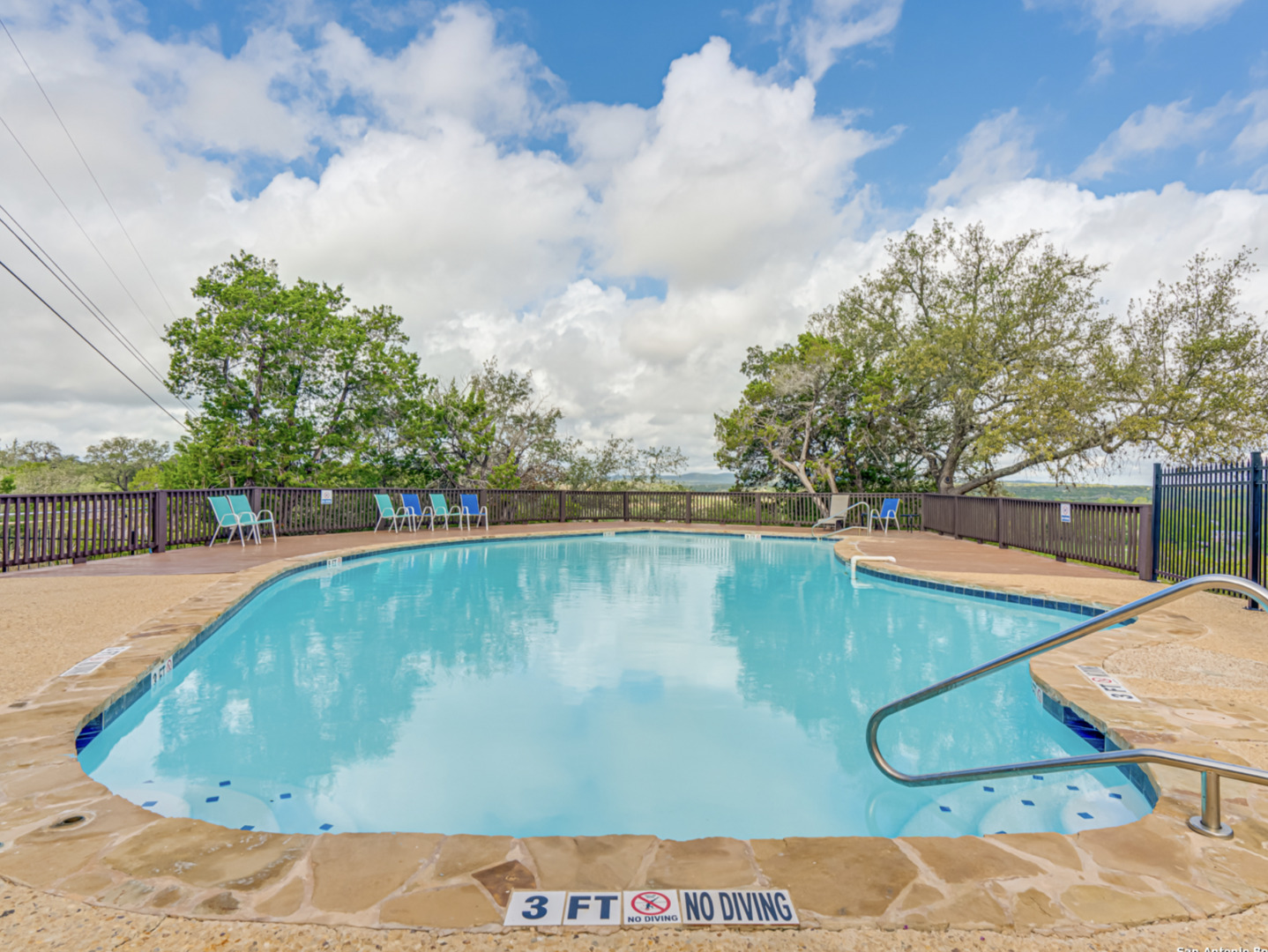 259 Forest Ridge Drive Lakehills, TX 78063 - Photo 22 of 30 a view of a swimming pool with a yard