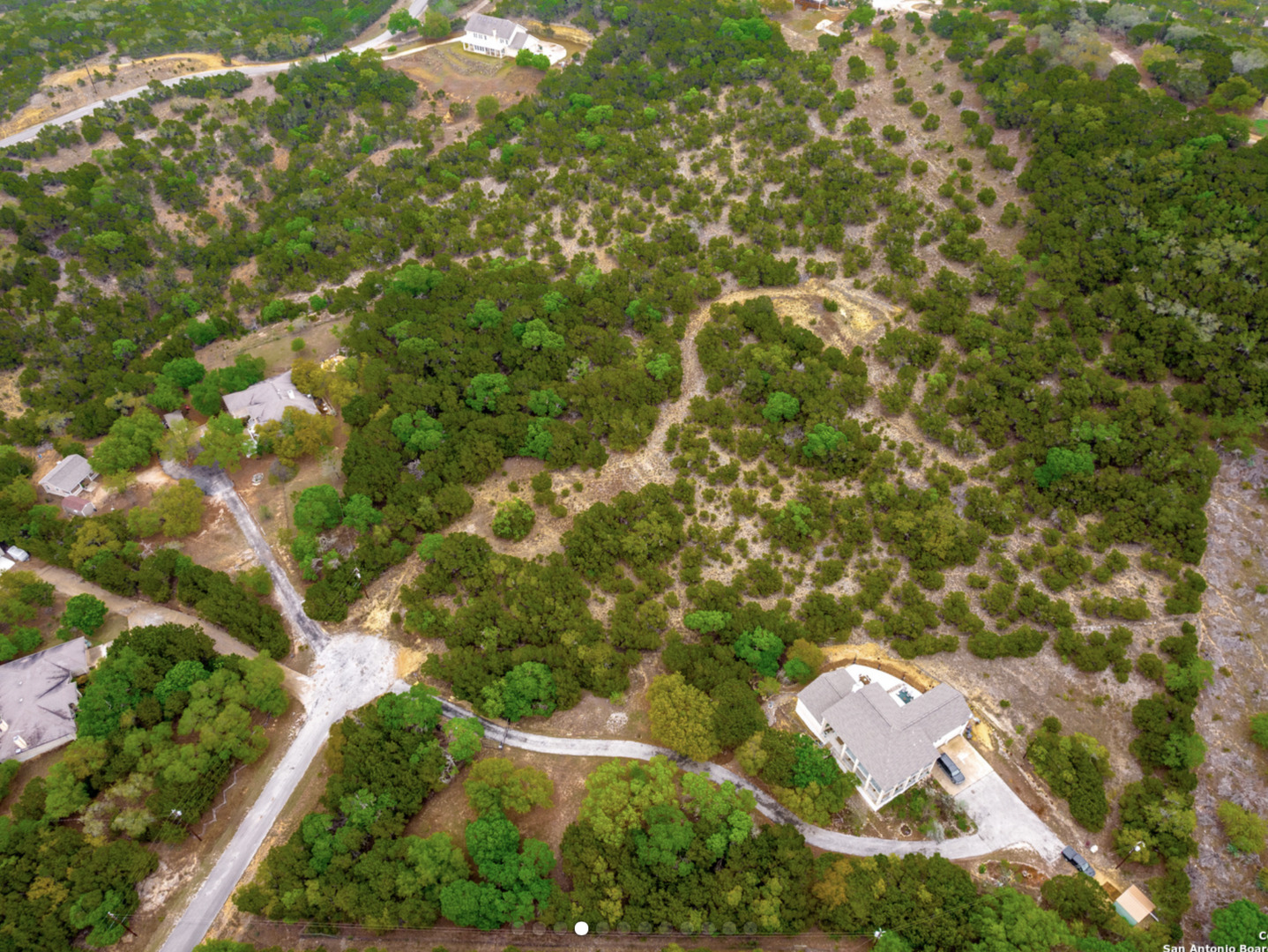 259 Forest Ridge Drive Lakehills, TX 78063 - Photo 4 of 30 an aerial view of residential house with outdoor space and trees all around