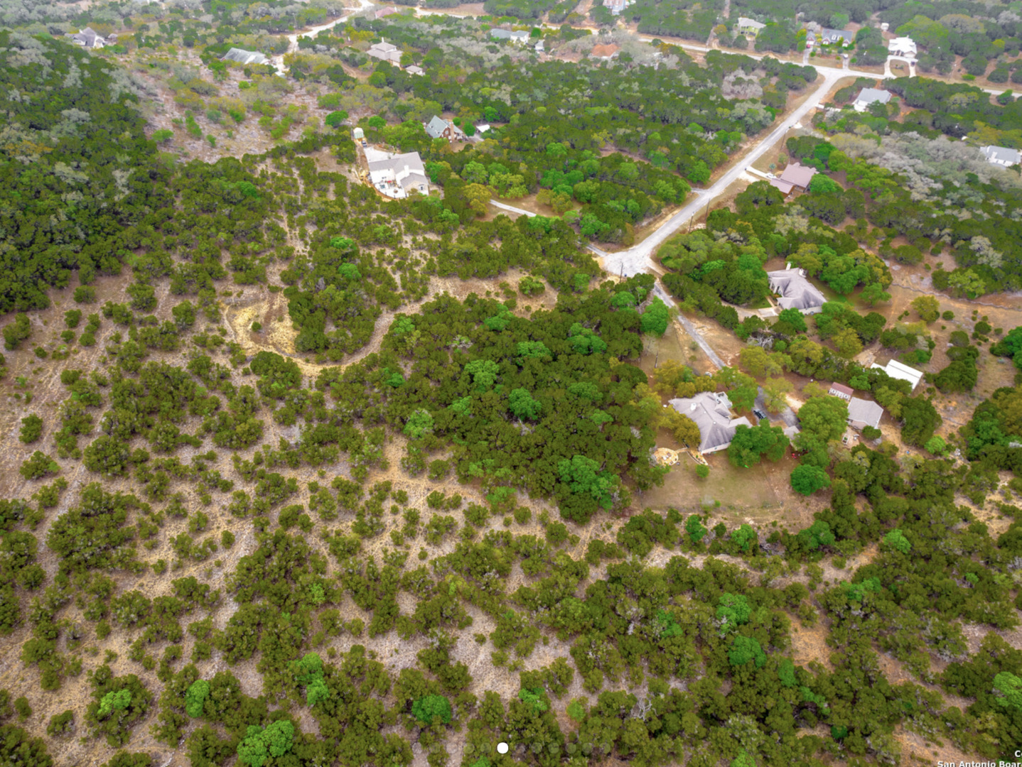 259 Forest Ridge Drive Lakehills, TX 78063 - Photo 6 of 30 a backyard of a house with a tree