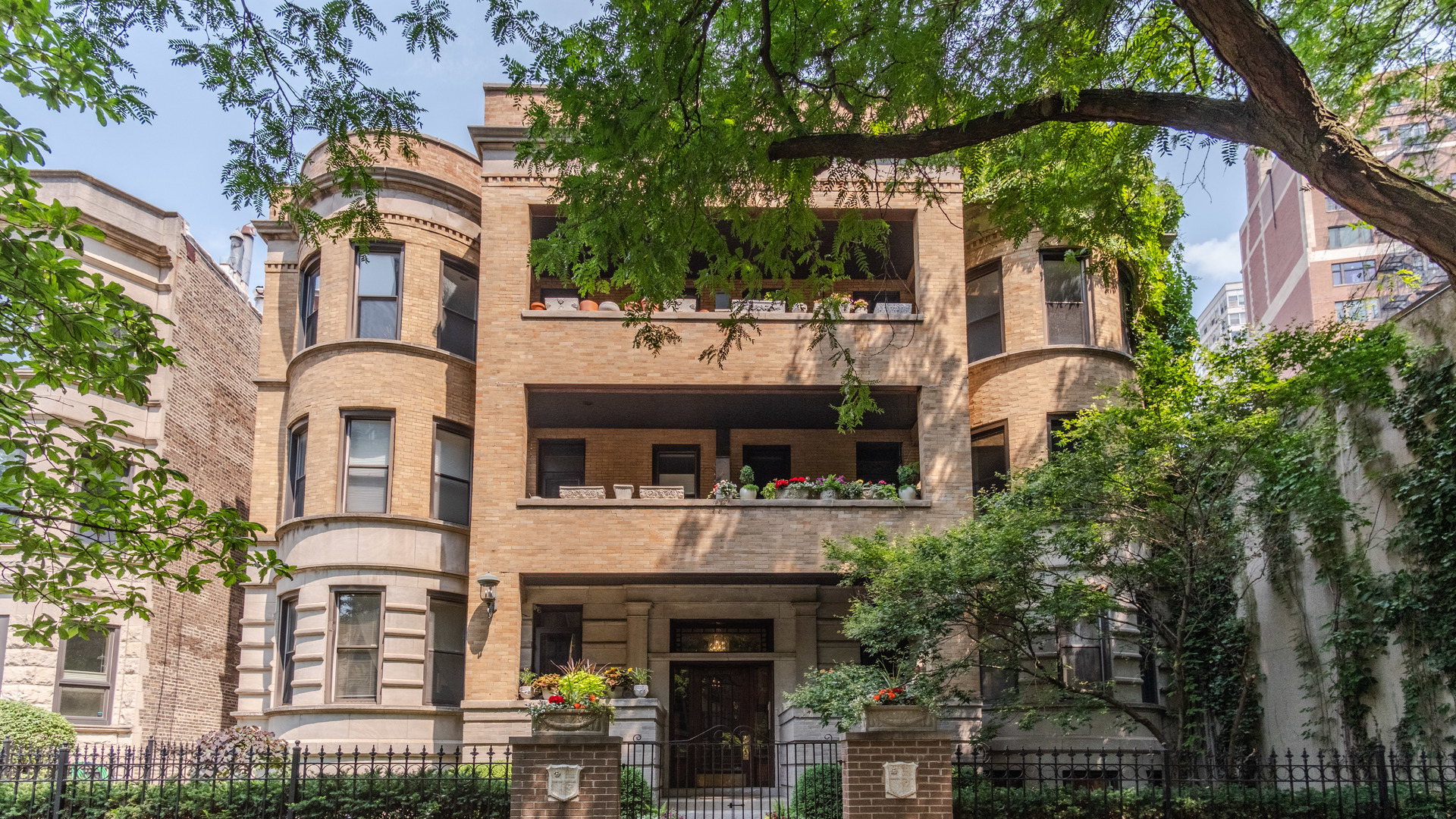 a front view of a residential apartment building with a yard