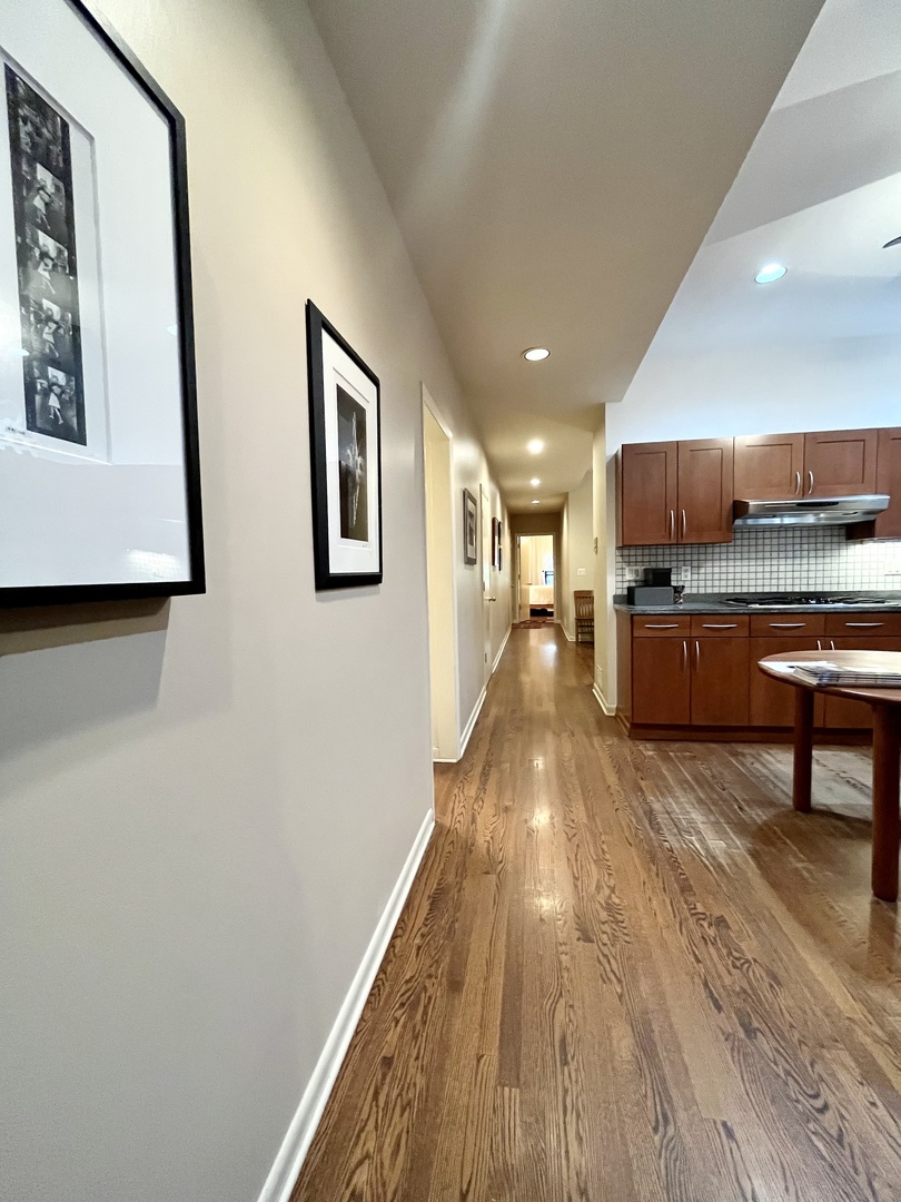 626 West Grace Street, Unit 1E Chicago, IL 60613 - Photo 13 of 29 a living room with stainless steel appliances furniture a rug and a wooden floor