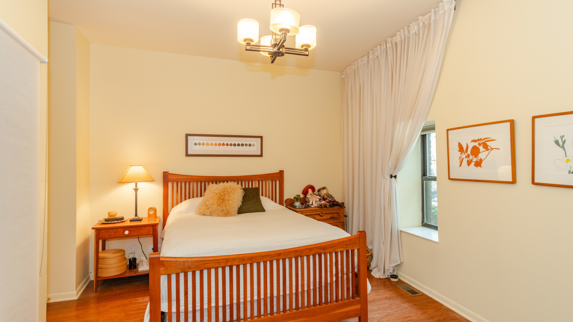 626 West Grace Street, Unit 1E Chicago, IL 60613 - Photo 15 of 29 a bedroom with a bed and a chandelier