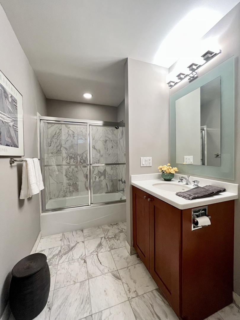 626 West Grace Street, Unit 1E Chicago, IL 60613 - Photo 17 of 29 a bathroom with a sink a toilet and shower