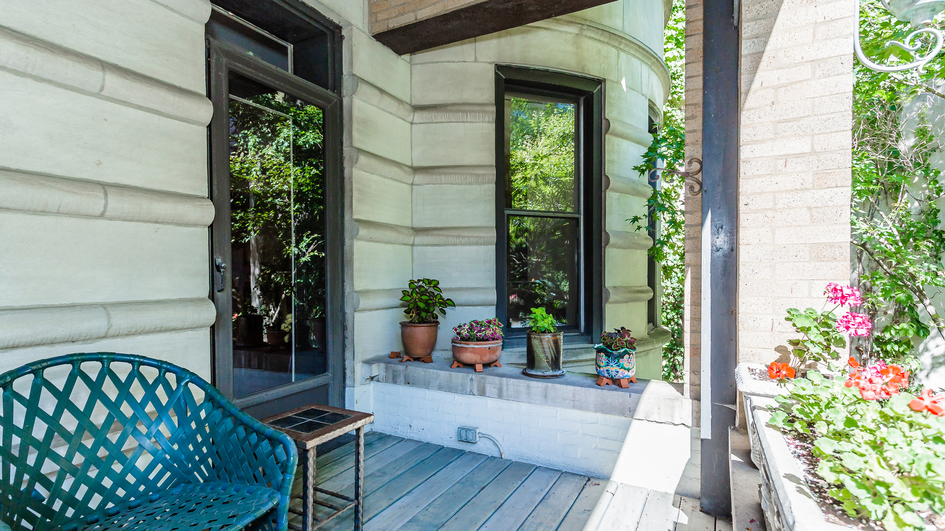 626 West Grace Street, Unit 1E Chicago, IL 60613 - Photo 26 of 29 a view of a porch with chairs and potted plants
