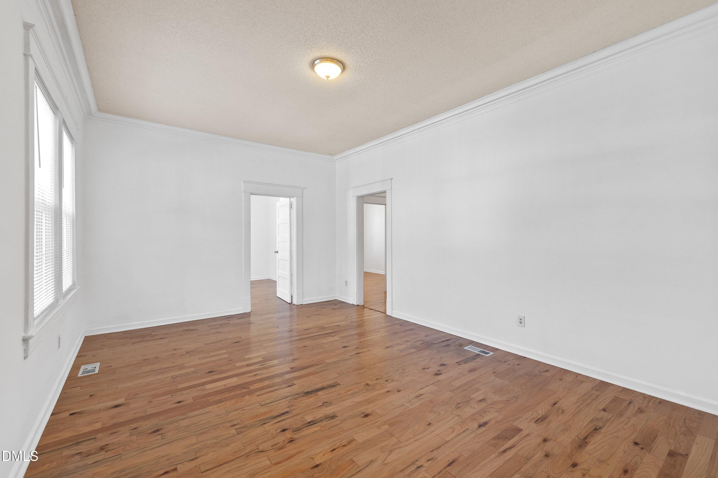 3010 Burrell Place Raleigh, NC 27607 - Photo 18 of 46 a view of an empty room with wooden floor and a window