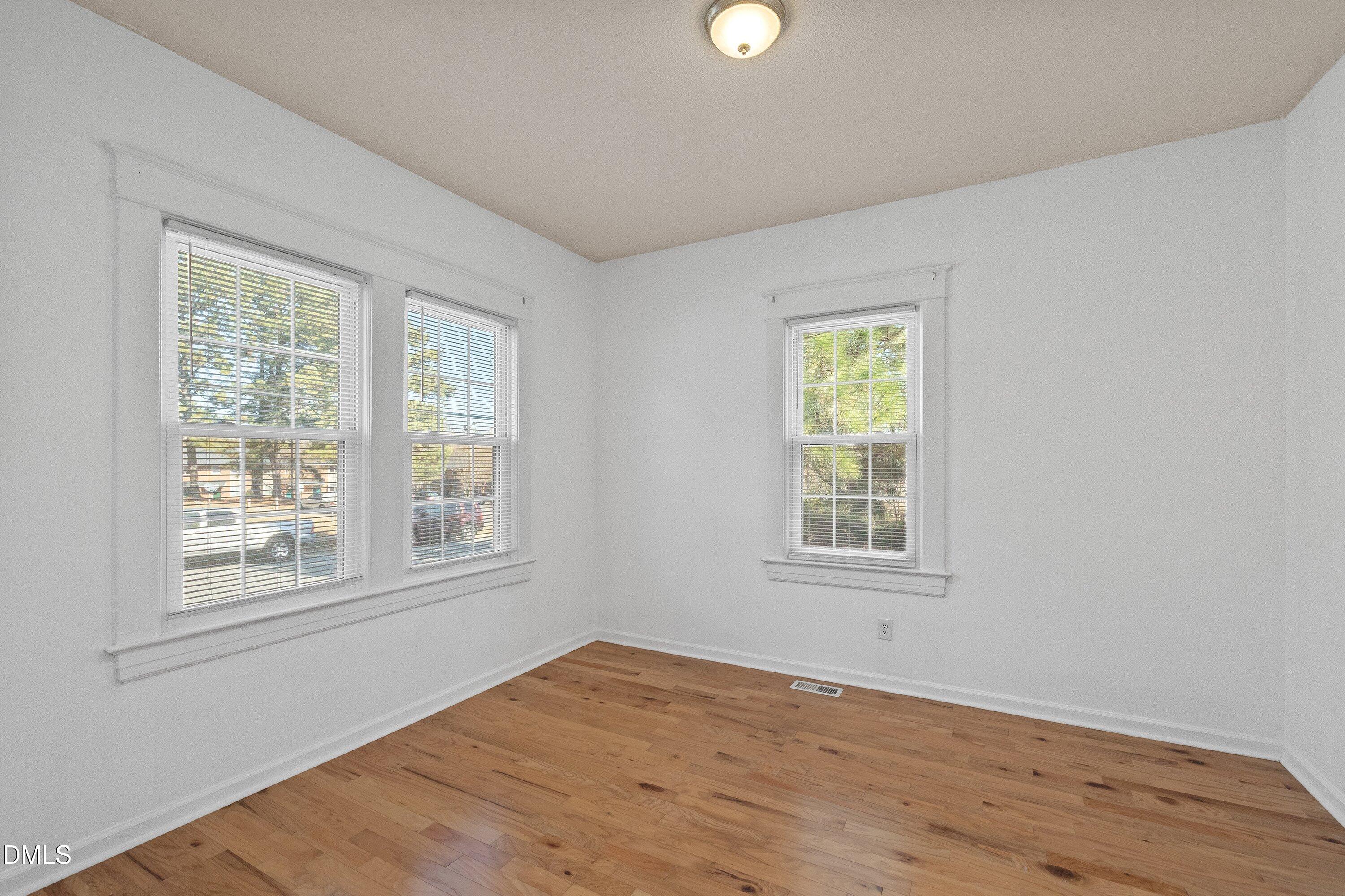 3010 Burrell Place Raleigh, NC 27607 - Photo 20 of 46 an empty room with wooden floor and windows
