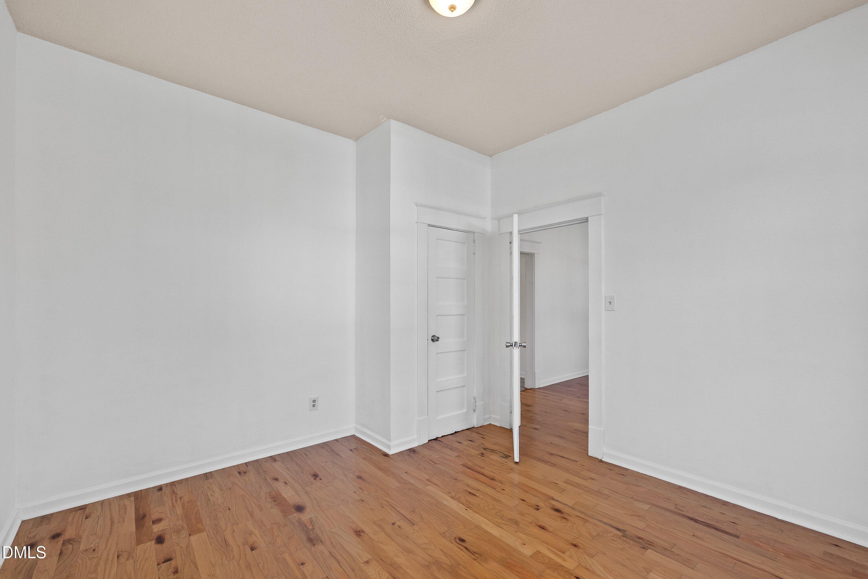 3010 Burrell Place Raleigh, NC 27607 - Photo 21 of 46 a view of an empty room with wooden floor