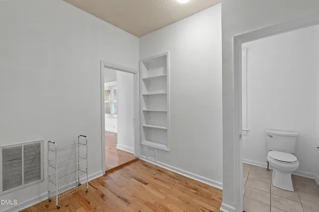 a bathroom with a toilet sink vanity and mirror