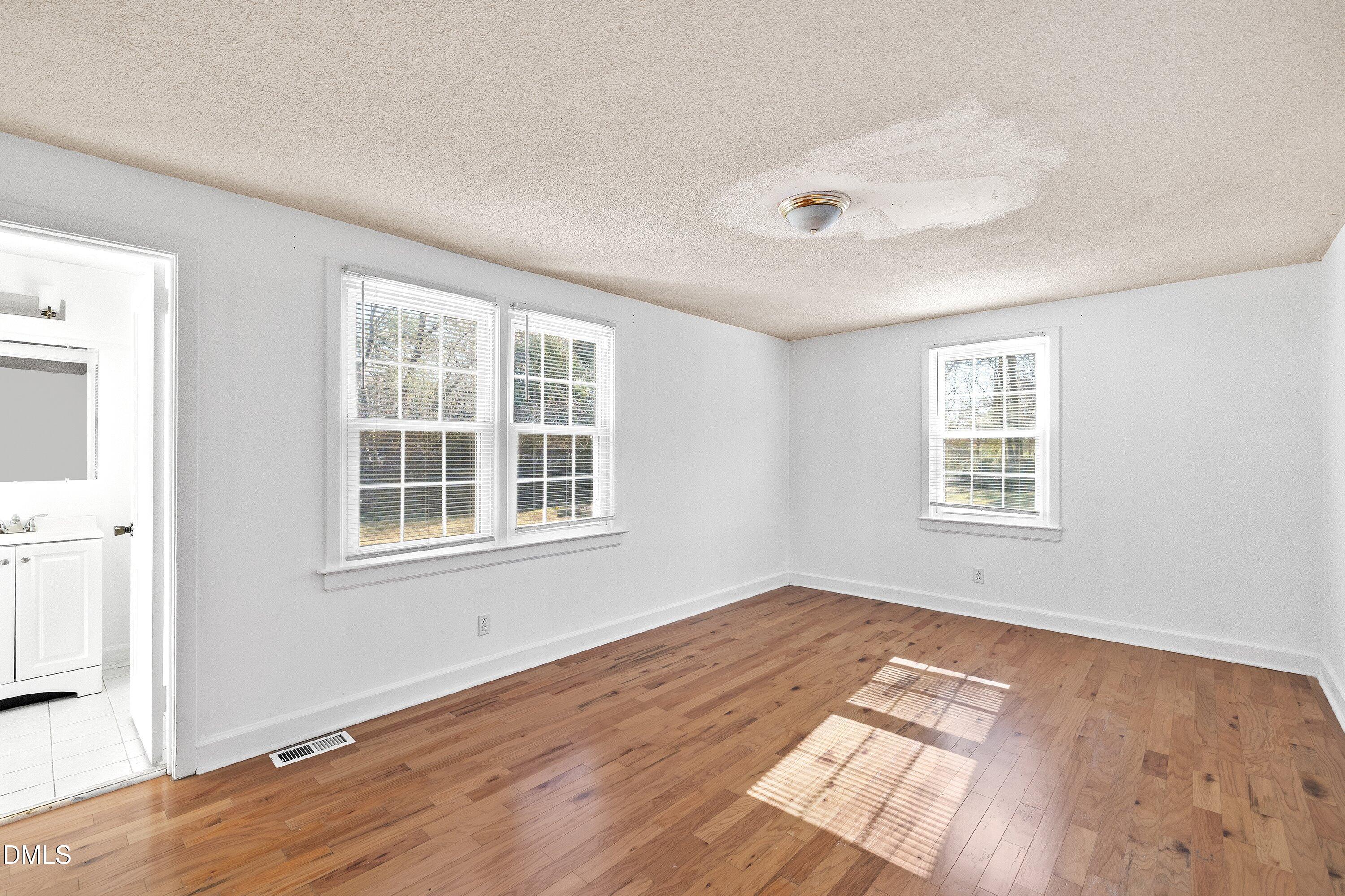 3010 Burrell Place Raleigh, NC 27607 - Photo 30 of 46 an empty room with wooden floor and windows