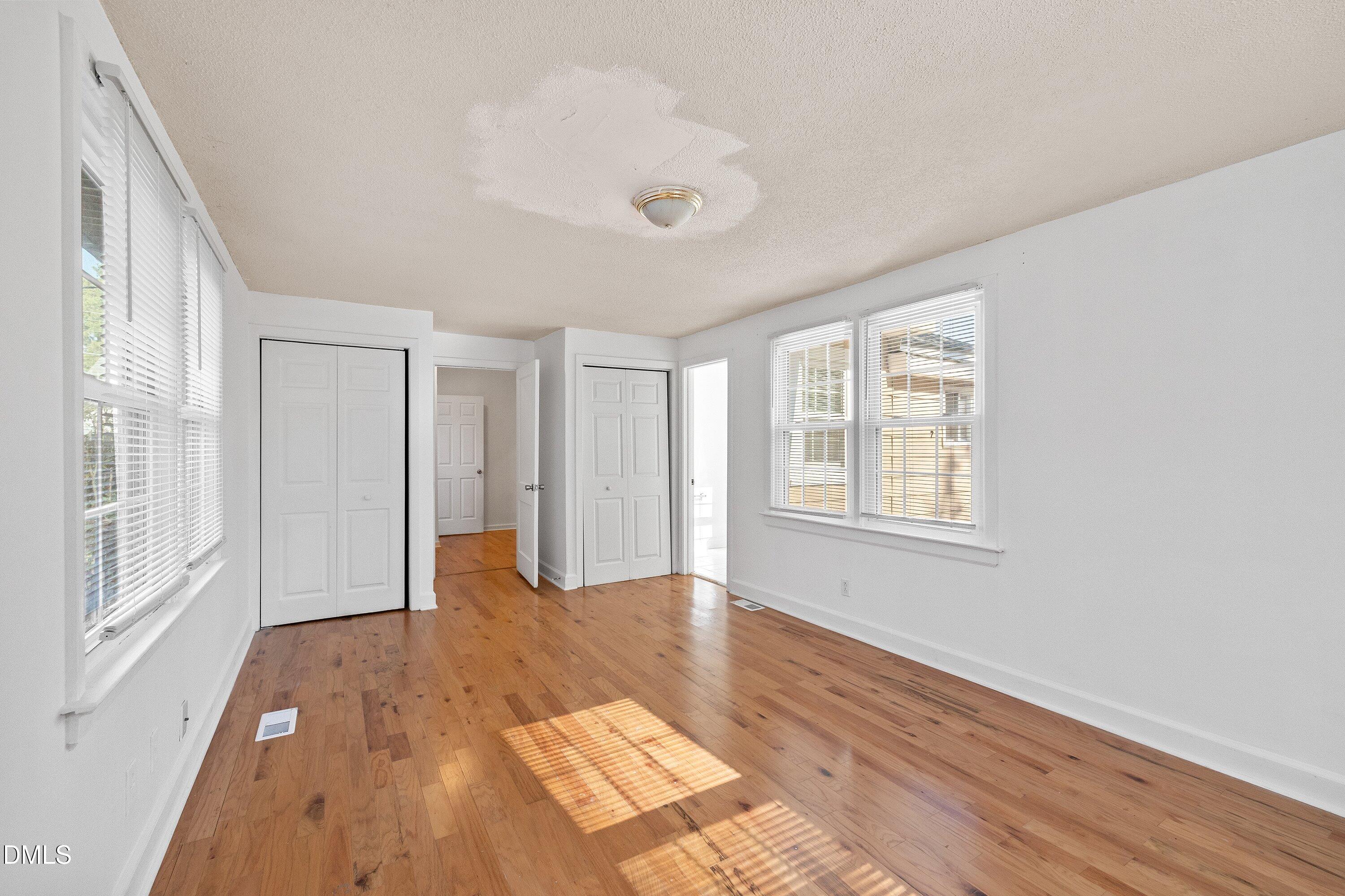 3010 Burrell Place Raleigh, NC 27607 - Photo 31 of 46 a view of an empty room with wooden floor and a window