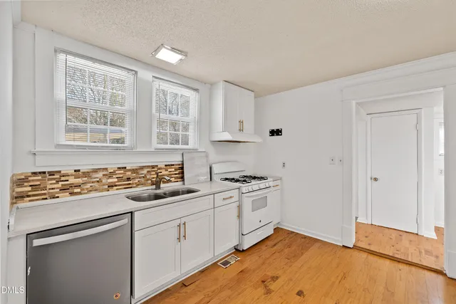 a kitchen with a refrigerator and window