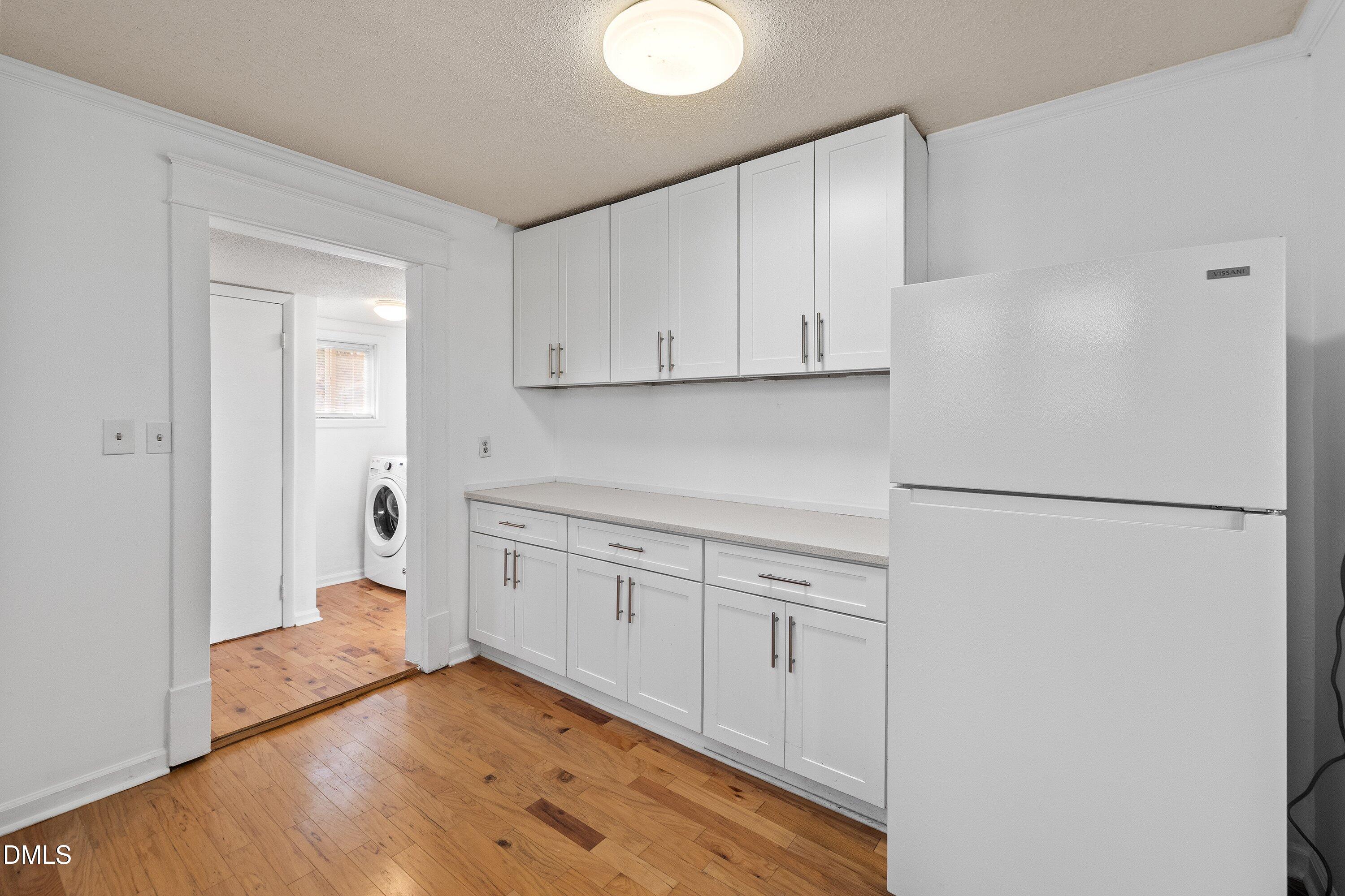 3010 Burrell Place Raleigh, NC 27607 - Photo 36 of 46 a kitchen with white cabinets and refrigerator