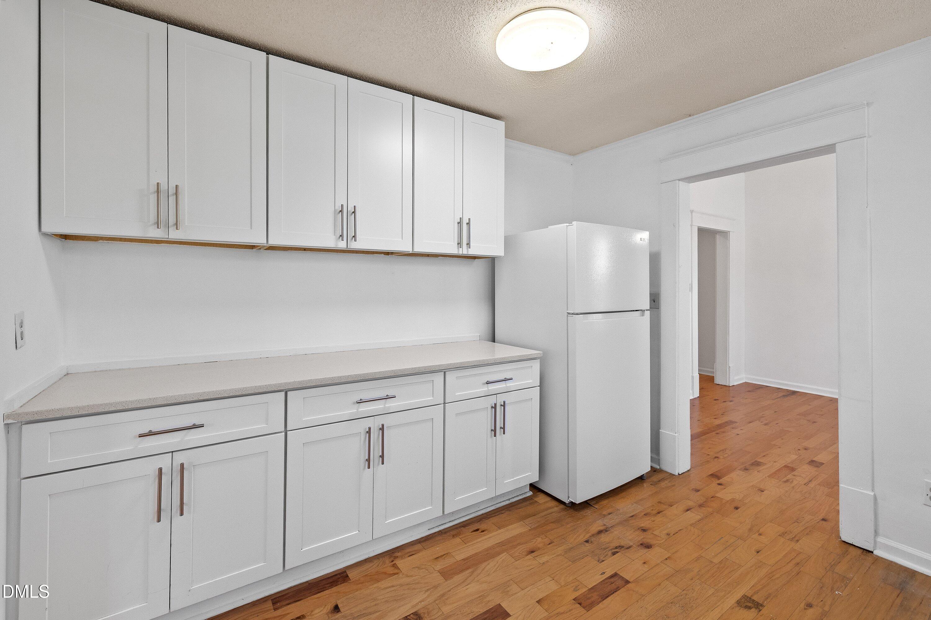 3010 Burrell Place Raleigh, NC 27607 - Photo 38 of 46 a kitchen with a refrigerator and cabinets