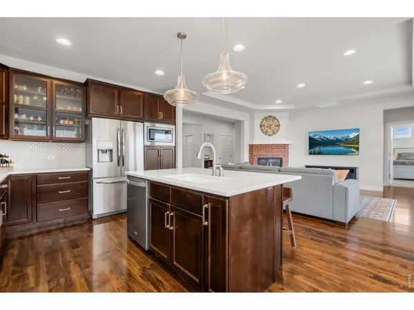 a kitchen with stainless steel appliances a sink stove and refrigerator