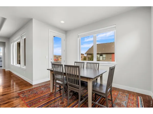 a kitchen with stainless steel appliances granite countertop a sink a stove and a wooden floors