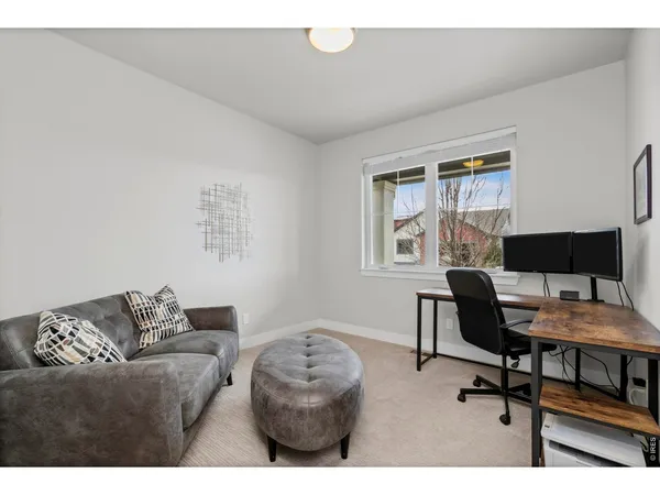 a view of a dining room with furniture a rug and wooden floor