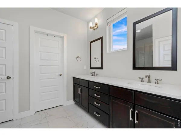 a bedroom with a large bed and a flat screen tv