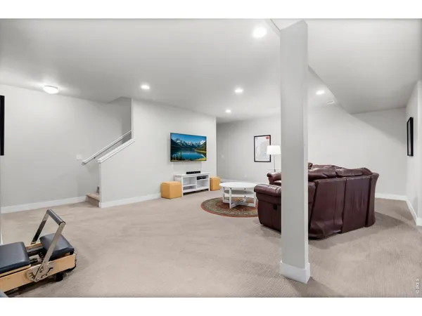 a living room with furniture a lamp and a chandelier