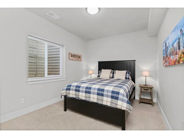 a bedroom with a bed and a night stand