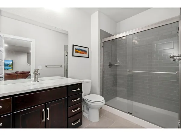 a bedroom with a bed lamp and a window