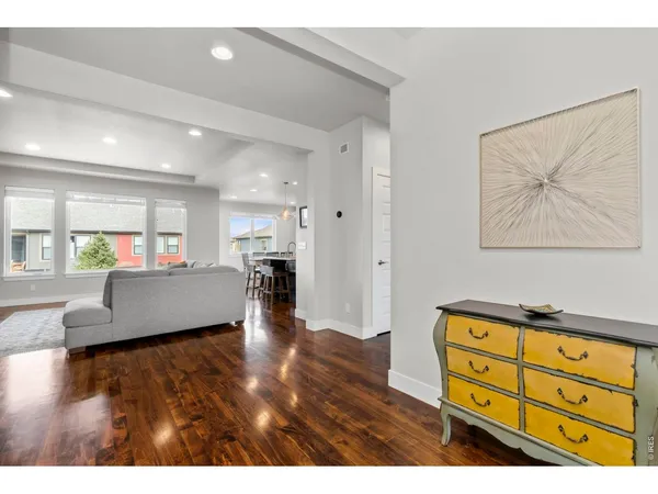 a living room with furniture and a kitchen view