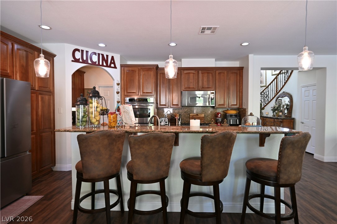 2729 Kildrummie Street Henderson, NV 89044 - Photo 10 of 42 Culinary delights await in this well-appointed kitchen, featuring a spacious island and gleaming stainless steel appliances.
