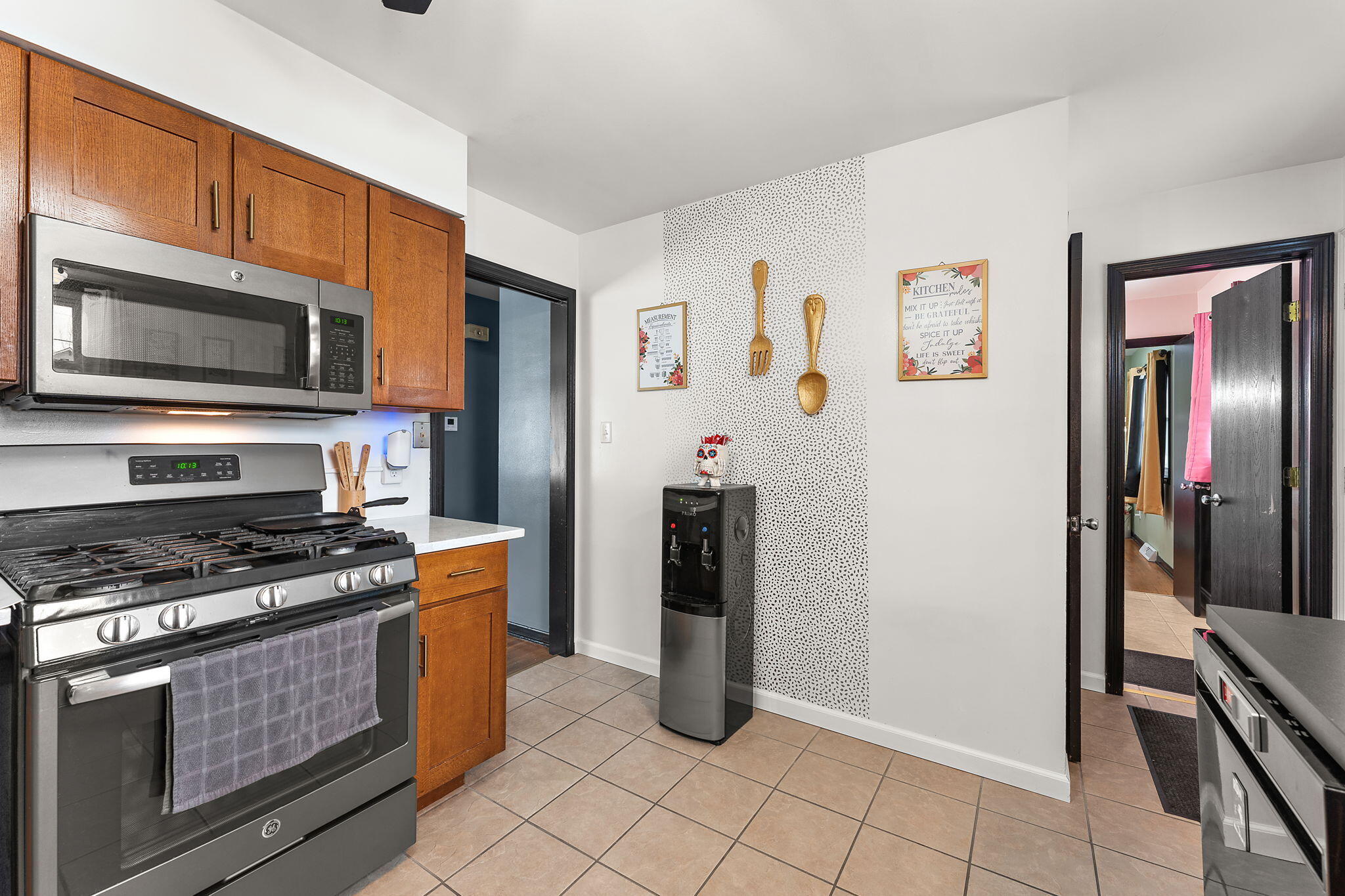5345 Johnson Street Merrillville, IN 46410 - Photo 11 of 26 a kitchen with granite countertop a stove and a refrigerator