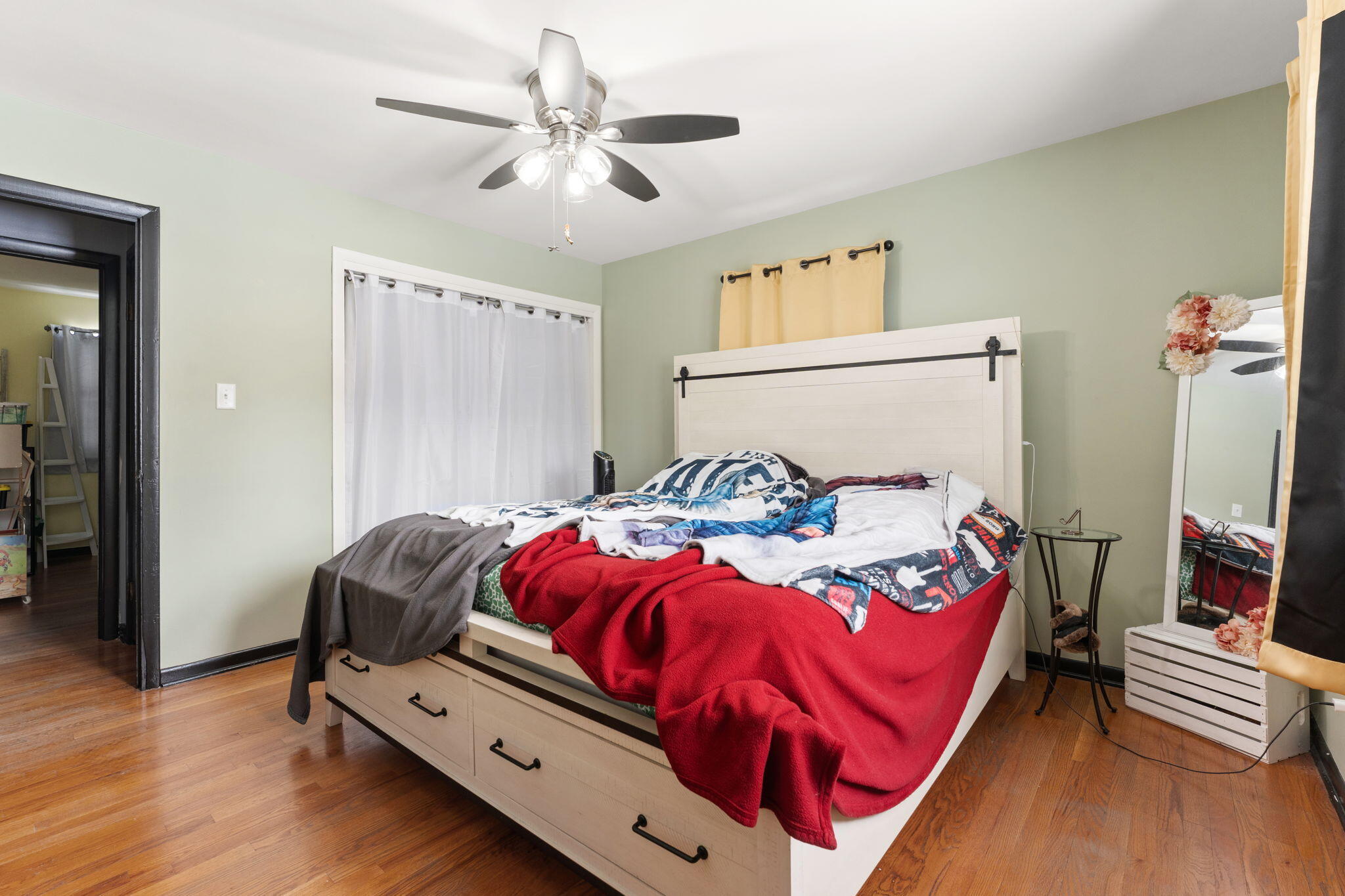 5345 Johnson Street Merrillville, IN 46410 - Photo 16 of 26 a bedroom with a bed and a chandelier