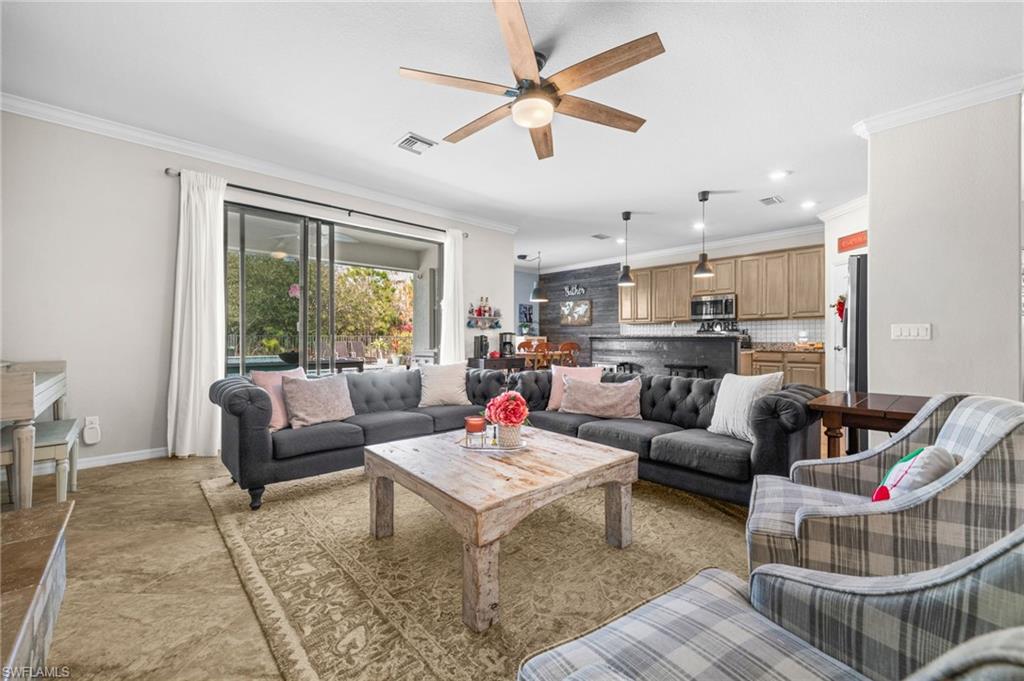 4754 Abaca Circle Naples, FL 34119 - Photo 4 of 46 a living room with furniture and a large window