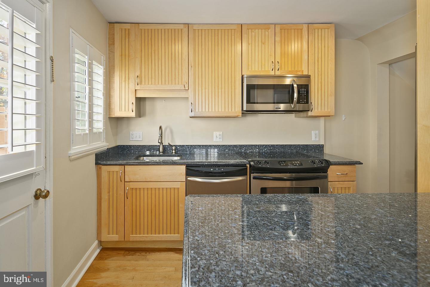 4634 31st Road South Arlington, VA 22206 - Photo 6 of 36 a kitchen with stainless steel appliances granite countertop a stove a microwave and a sink
