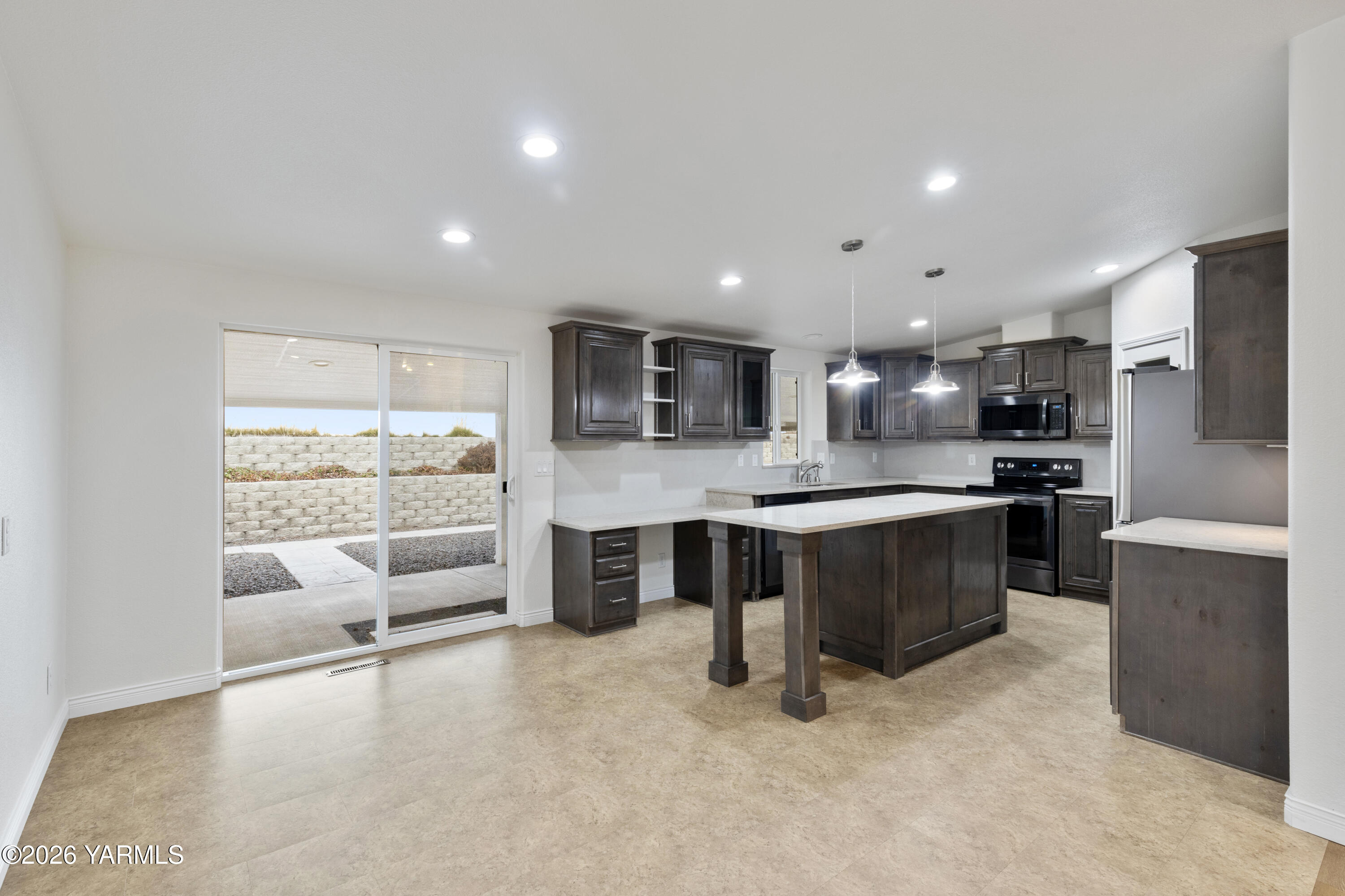 200 Bridle Way, Unit 157 Yakima, WA 98901 - Photo 13 of 30 a large kitchen with stainless steel appliances kitchen island granite countertop a large counter top and a stove top oven