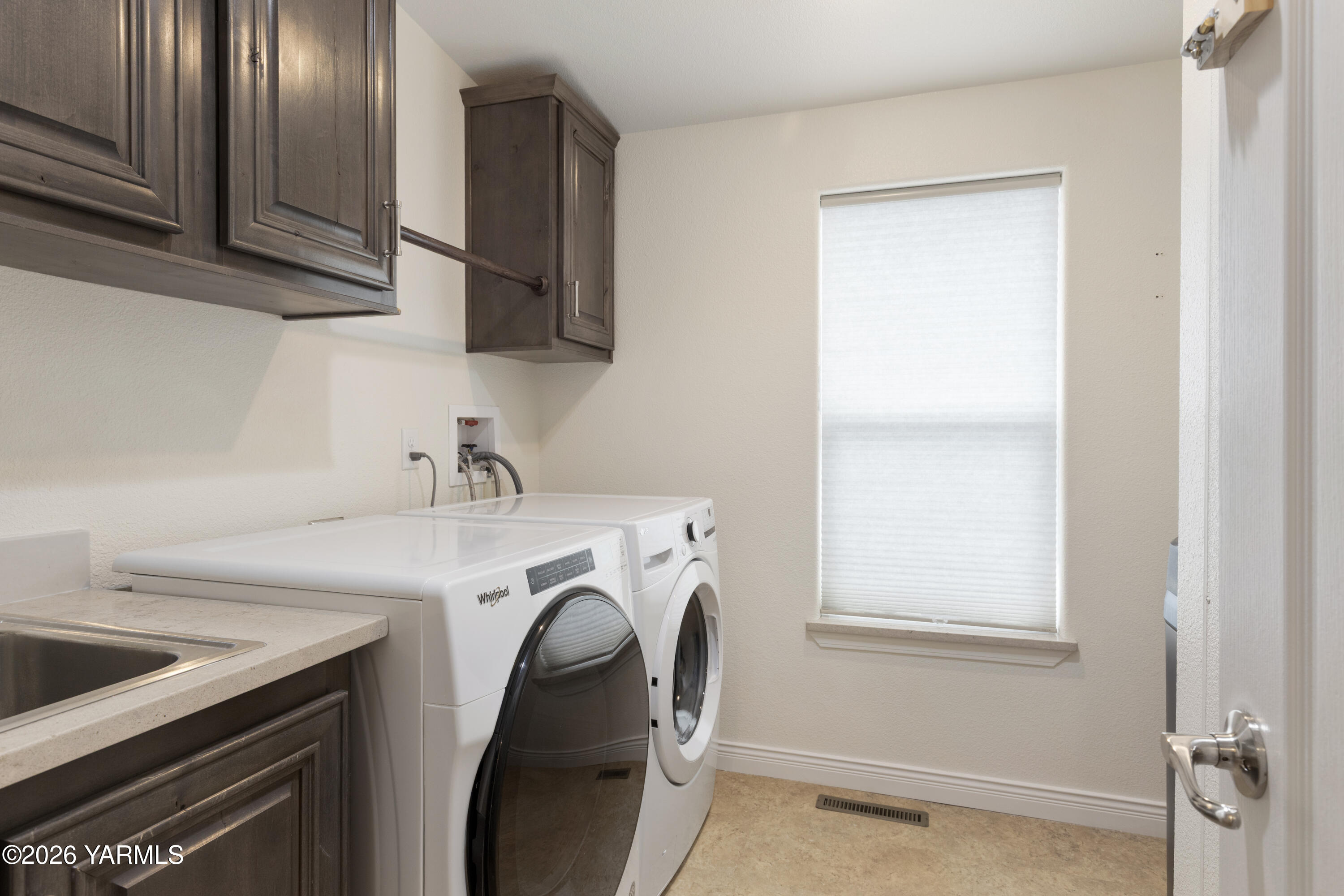 200 Bridle Way, Unit 157 Yakima, WA 98901 - Photo 24 of 30 a utility room with cabinets washer and dryer