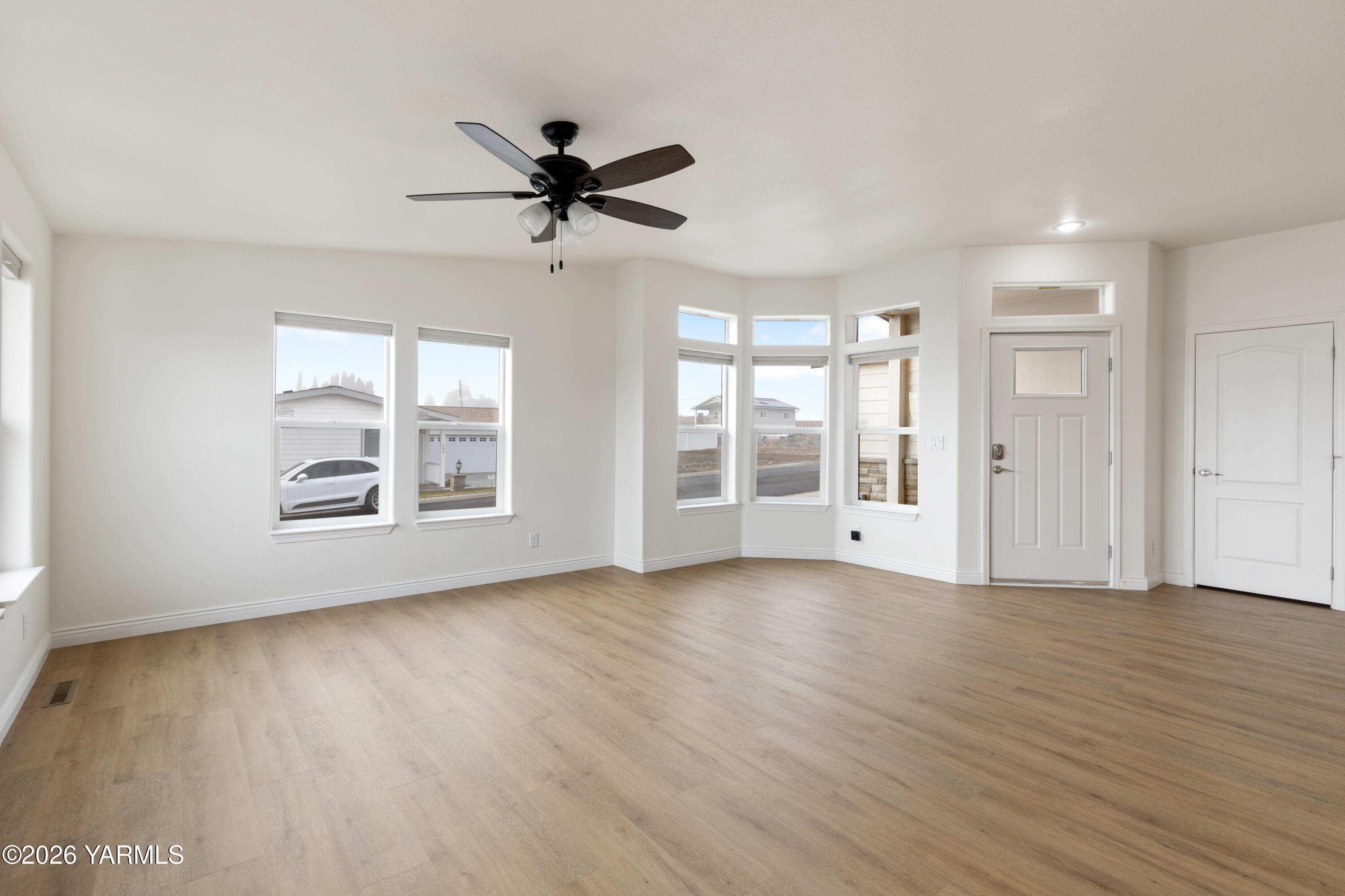 200 Bridle Way, Unit 157 Yakima, WA 98901 - Photo 3 of 30 a view of an empty room with a window and wooden floor