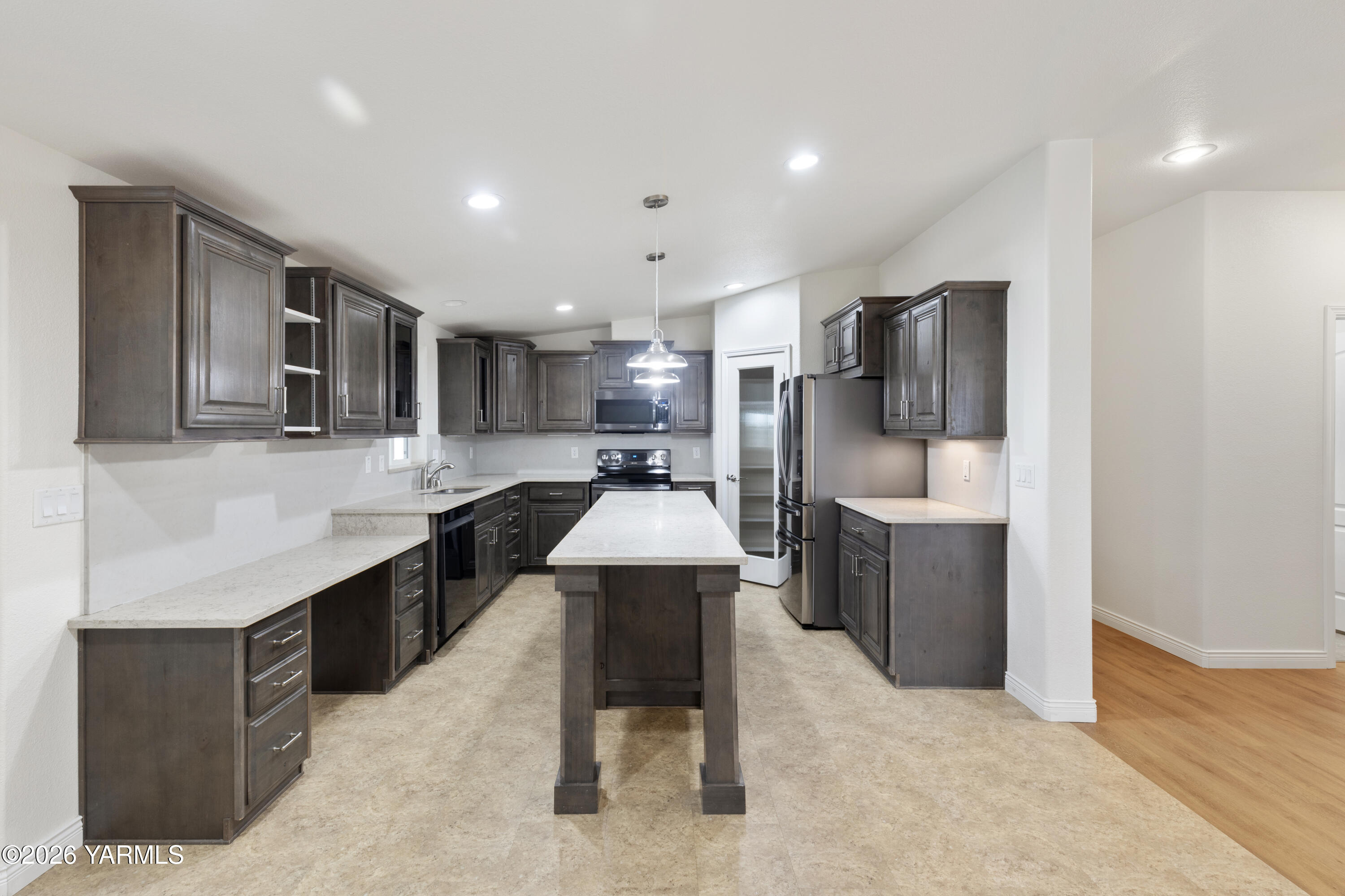 200 Bridle Way, Unit 157 Yakima, WA 98901 - Photo 9 of 30 a kitchen with stainless steel appliances kitchen island granite countertop a refrigerator and a stove top oven