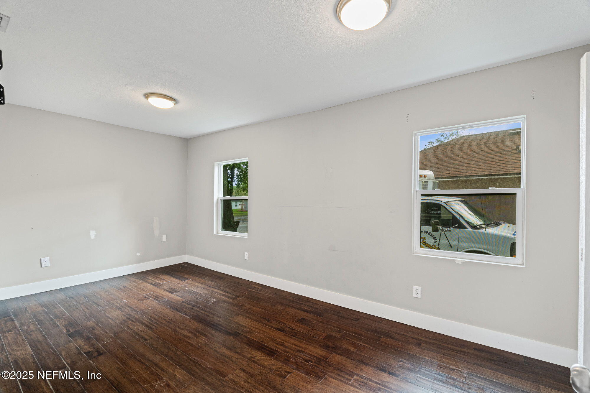 2310 Jerusalem Street Jacksonville, FL 32207 - Photo 19 of 39 a view of an empty room with wooden floor and window