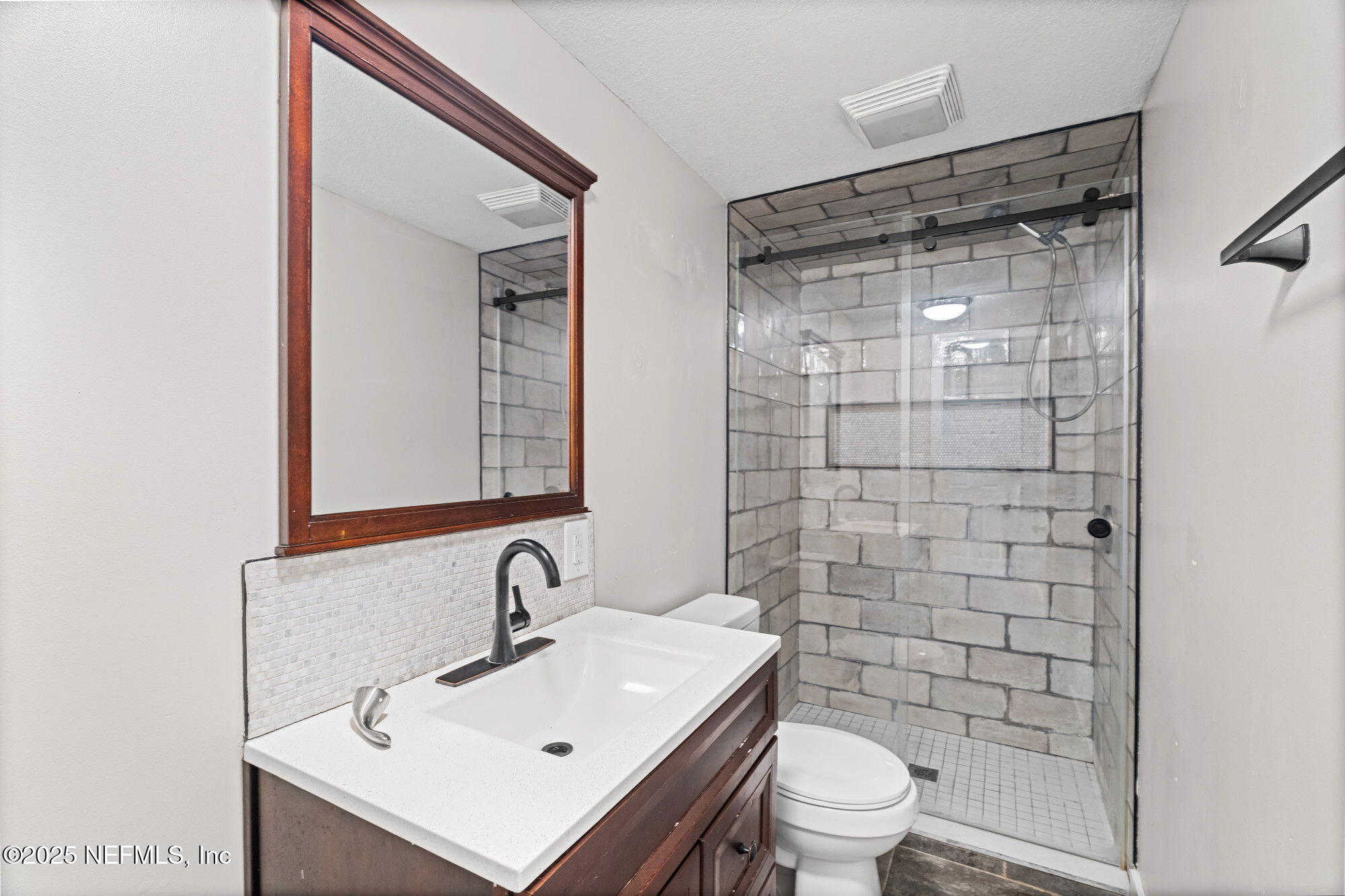 2310 Jerusalem Street Jacksonville, FL 32207 - Photo 21 of 39 a bathroom with a sink a toilet and shower