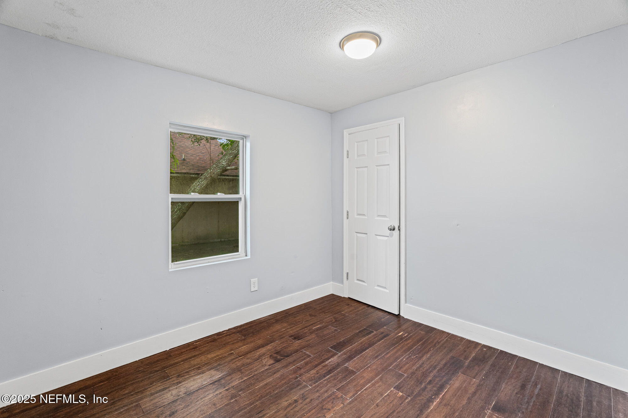 2310 Jerusalem Street Jacksonville, FL 32207 - Photo 22 of 39 an empty room with wooden floor and windows