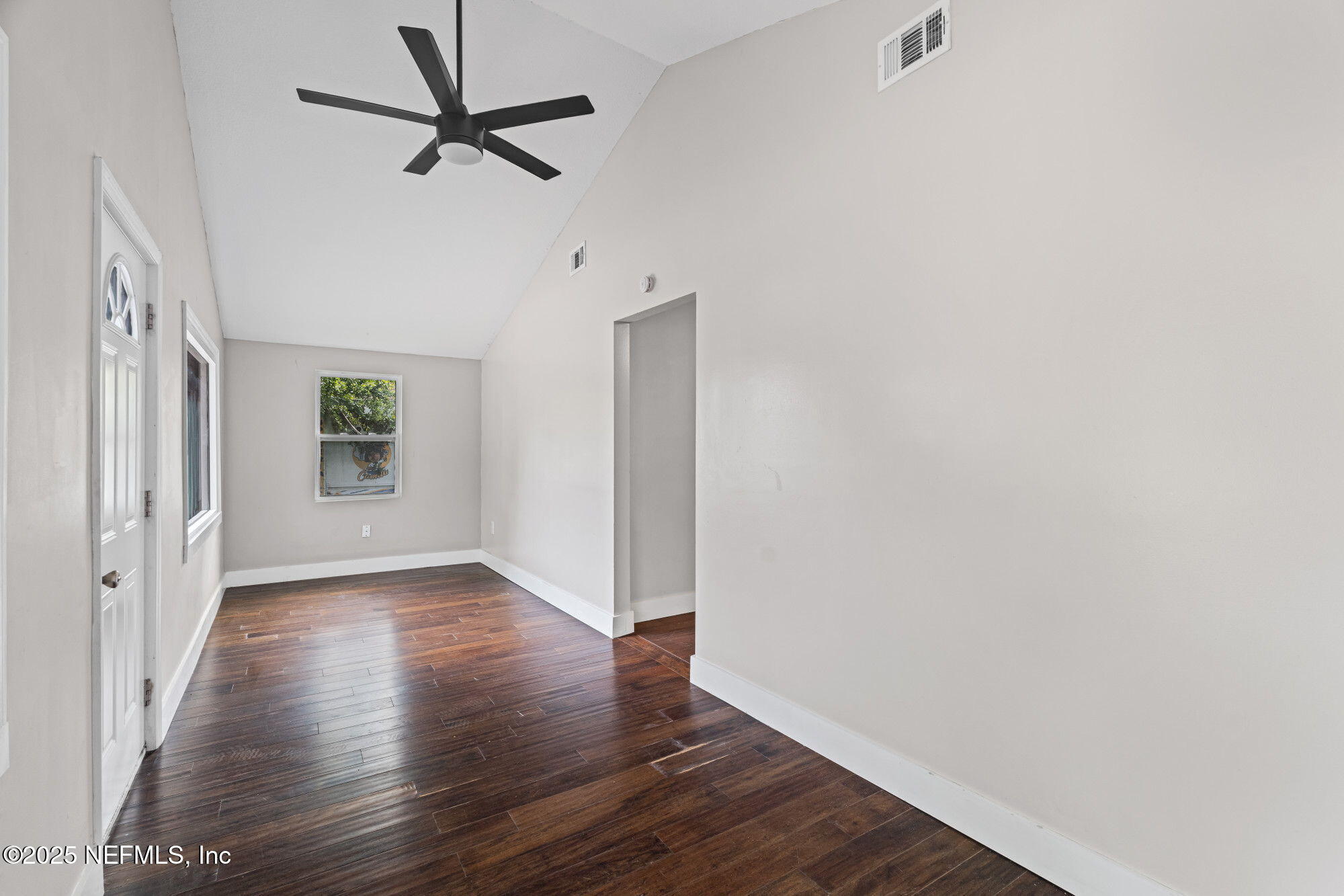 2310 Jerusalem Street Jacksonville, FL 32207 - Photo 5 of 39 wooden floor in an empty room with a window