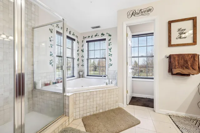 a bathroom with a bathtub and a shower