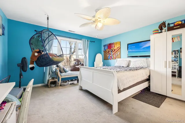 a bedroom with a bed a dresser and potted plants