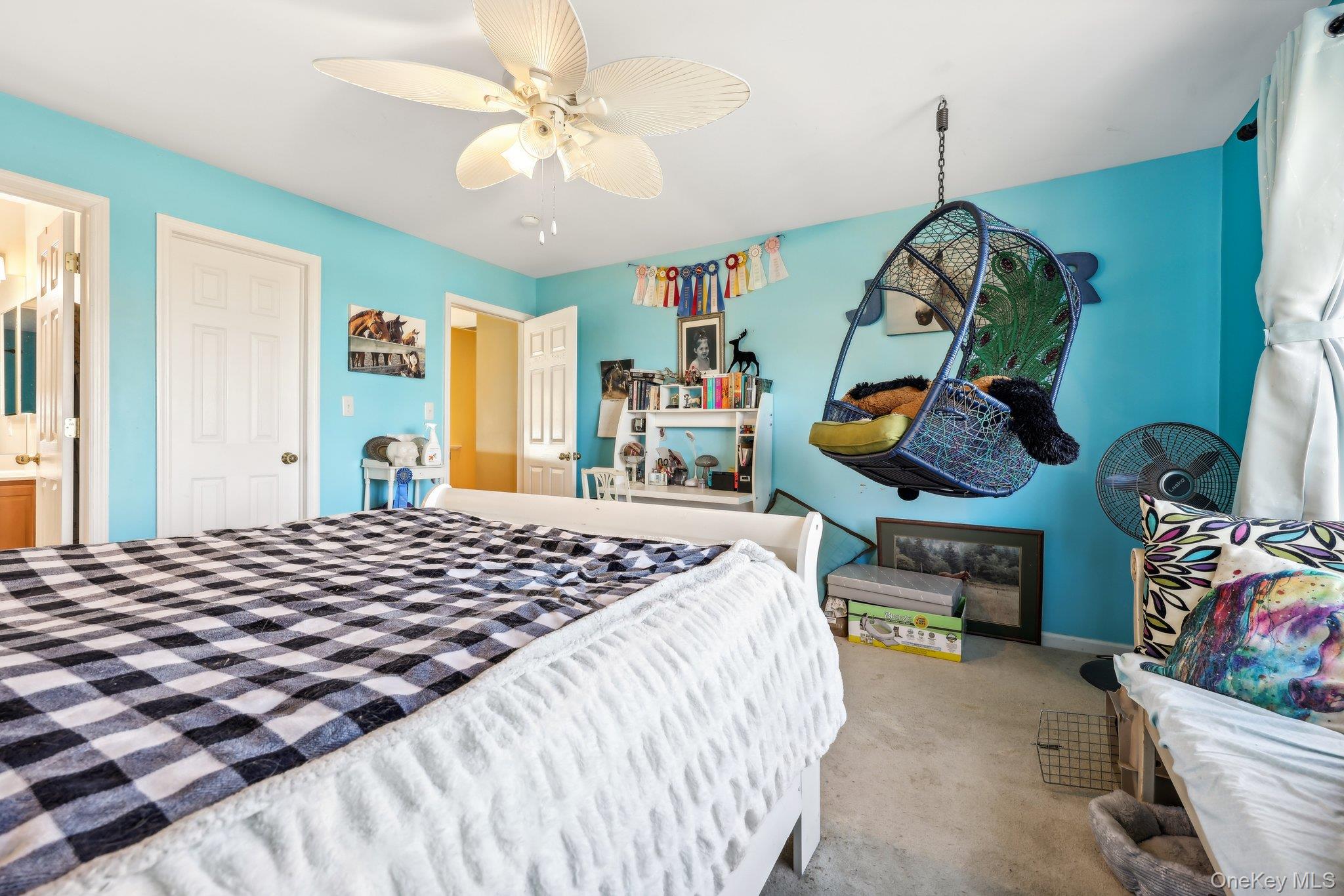 13 Mansion Ridge Boulevard Monroe, NY 10950 - Photo 30 of 49 a bedroom with a bed and a chandelier