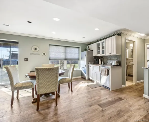 a view of a dining room with furniture and wooden floor