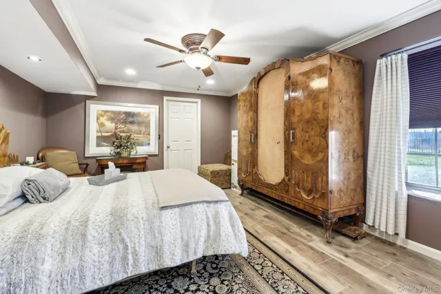 a bedroom with a large bed and a chandelier