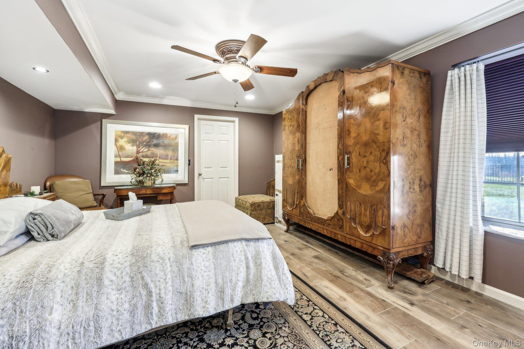 13 Mansion Ridge Boulevard Monroe, NY 10950 - Photo 35 of 49 a bedroom with a large bed and a chandelier