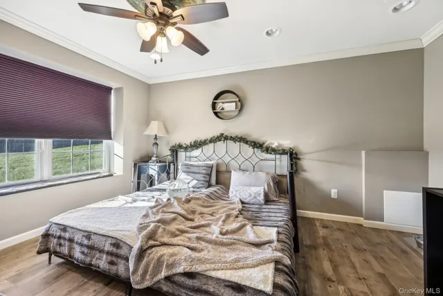 a bedroom with a bed and window with lamp