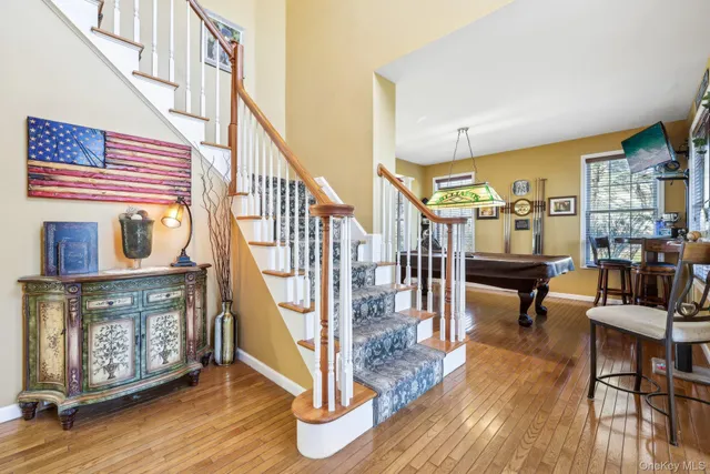 a view of entryway livingroom and hall with wooden floor