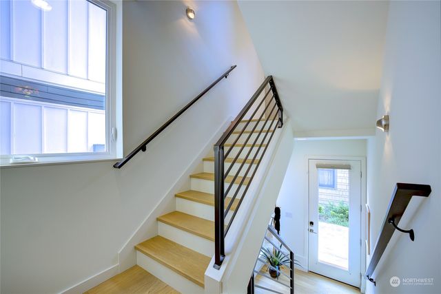 a view of staircase with wooden floor and a window