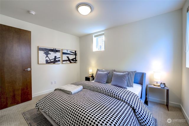 a bedroom with a bed and a night stand