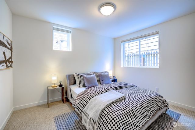 a bathroom with a sink a toilet a mirror and shower