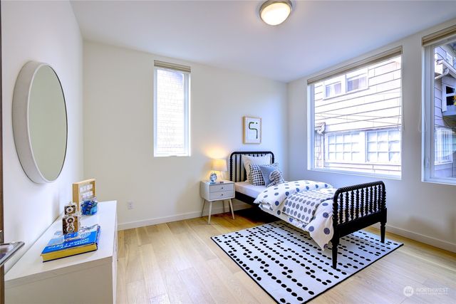 a bathroom with a granite countertop sink toilet a mirror a vanity and shower
